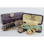 A COLLECTION OF JEWELLERY, to include an early 20th Century seed pearl flower bar brooch, stamped '