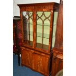 A REPRODUCTION MAHOGANY ASTRAGAL GLAZED TWO DOOR DISPLAY CABINET above double cupboard doors,