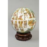 A BLOWN GLASS SPHERE, the interior with Victorian decoupage prints of children, flowers and animals,