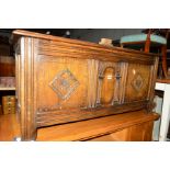 A REPRODUCTION CARVED OAK TRIPLE PANEL BLANKET CHEST