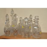 TEN VARIOUS CUT GLASS DECANTERS/CLARET JUG, to include a pair, height 30.5cm (10)