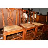 A SET OF THREE EARLY 19TH CENTURY OAK RUSH SEATED CHIPPENDALE STYLE CHAIRS, together with three