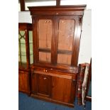 A VICTORIAN MAHOGANY GLAZED DOOR BOOKCASE, revealing three adjustable shelves, above a single long