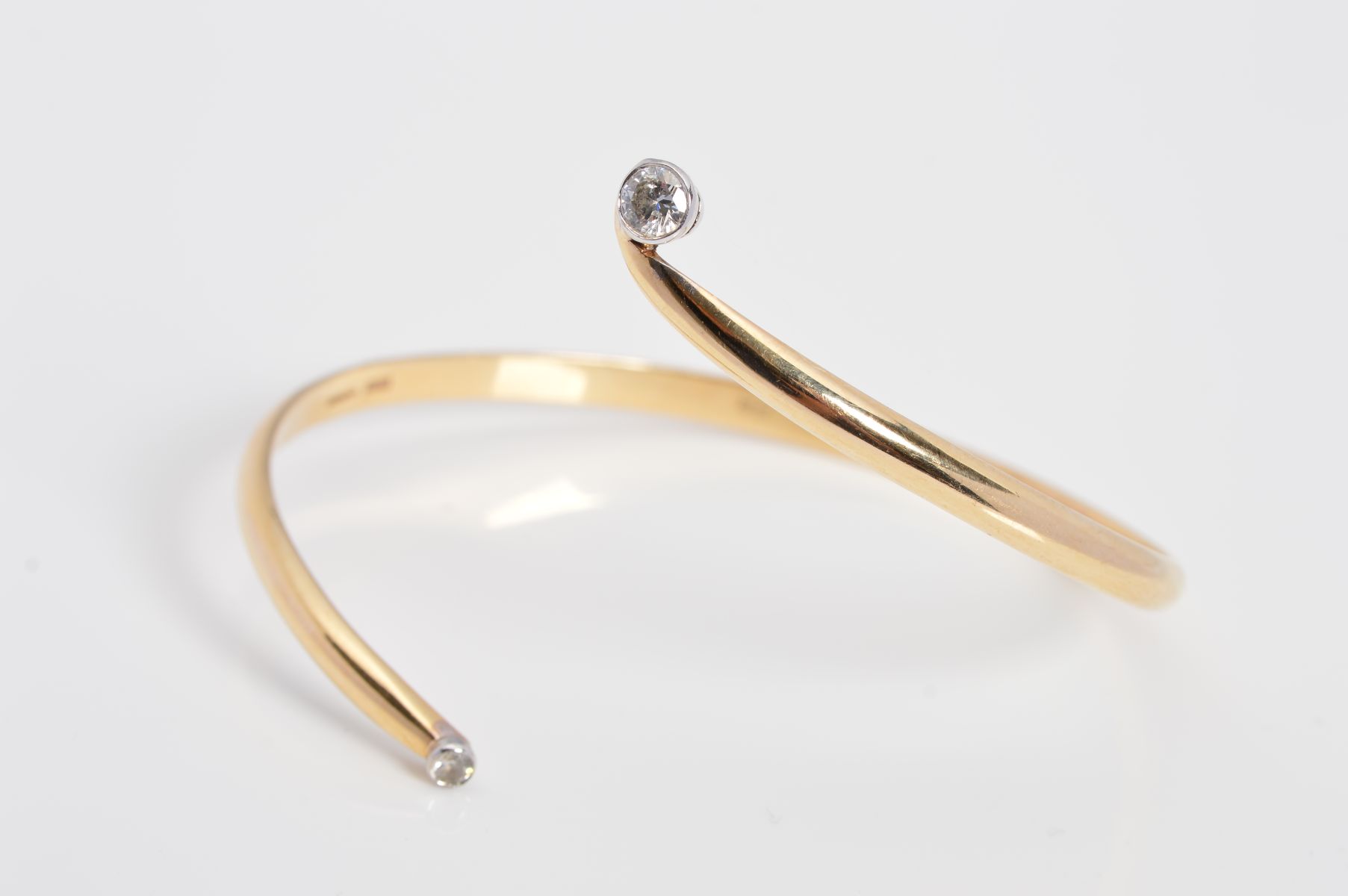 A MODERN 9CT GOLD DIAMOND TORC BANGLE, two modern round brilliant cut diamonds, estimated total