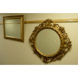 A GILT RESIN FRAMED CIRCULAR BEVELLED EDGE WALL MIRROR with scrolled and foliate decoration,