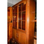 A 20TH CENTURY OAK GLAZED TWO DOOR BOOKCASE above two further doors, width 92cm x depth 32cm x