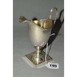 A GEORGE V MAPPIN & WEBB SILVER HELMET SHAPED PEDESTAL CREAM JUG, beaded rim, stepped circular