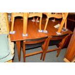 A 1960'S/70'S TEAK EXTENDING DINING TABLE on tapering legs and four chairs with black vinyl seats