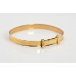 A MODERN 9CT GOLD CHRISTENING BANGLE, 'D is for Diamond' a small diamond set to the collar,