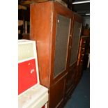 AN EARLY 20TH CENTURY STAINED PINE GLAZED FOUR DOOR CUPBOARD above a single long drawer, width 114cm