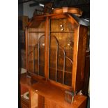 AN ART DECO WALNUT TWO DOOR BOOKCASE, with canted corners, width 94cm x depth 27cm x height 110cm,