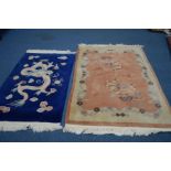 A CHINESE WOOLLEN ORANGE GROUND RUG, 188cm x 124cm, together with a Chinese blue ground rug and