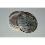 AN 18TH CENTURY WHITE METAL SNUFF BOX OF CIRCULAR FORM, the pull off cover with pierced and engraved
