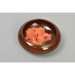 A SMALL MOORCROFT POTTERY LIPPED DISH, Hibiscus pattern on brown ground, impressed marks to base,