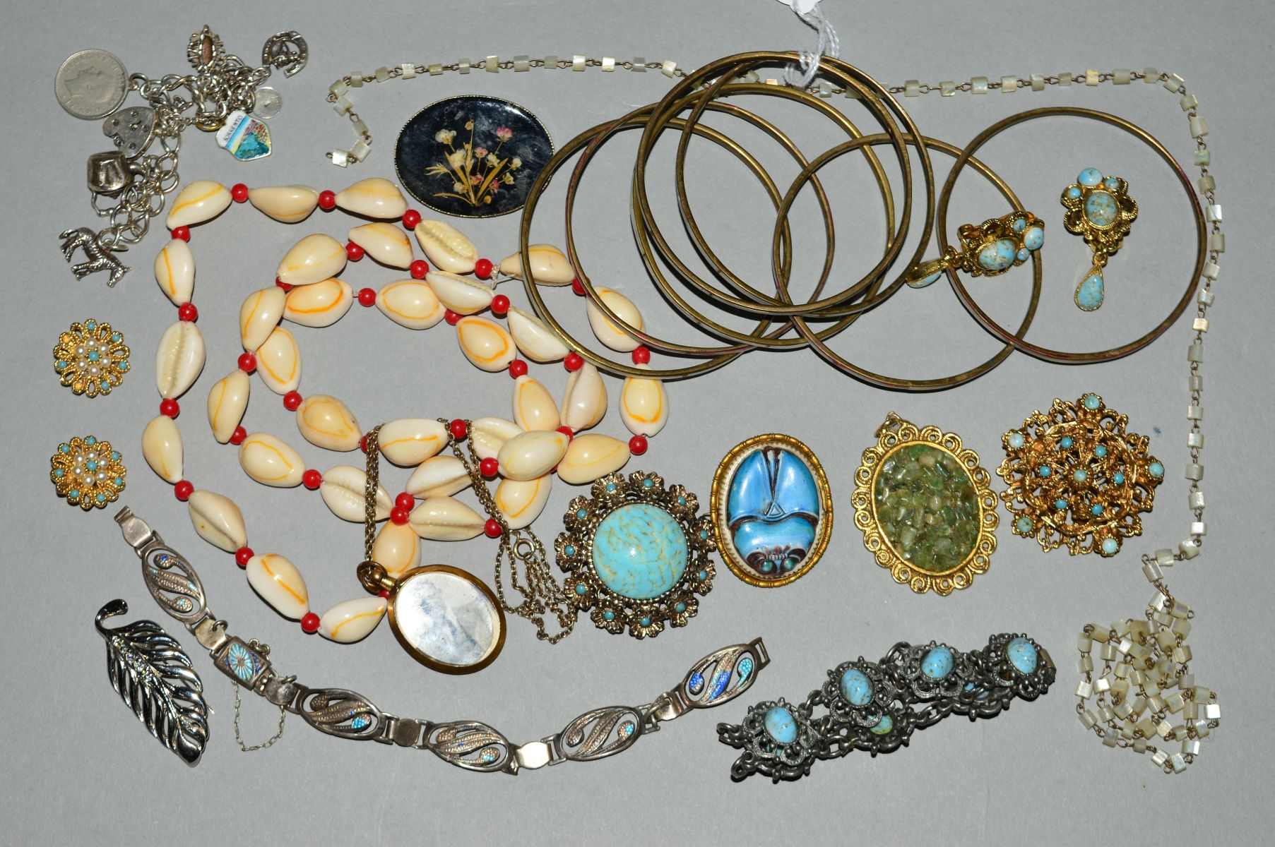 A COLLECTION OF COSTUME JEWELLERY, to include a silver charm bracelet with assorted charms, a