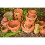 A COLLECTION OF TERRACOTTA POTS, URNS AND PLANTERS together with a composite circular planter and