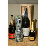 A GLASS VASE AND THREE EMPTY CHAMPAGNE BOTTLES, to include a magnum sized bottle (3L) (labels '