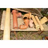A COLLECTION OF VICTORIAN TERRACOTTA PIPEWORK to include three treacle glazed pipes (8)