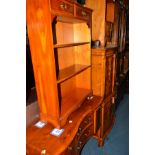 A REPRODUX YEW WOOD TWO DOOR DRINKS CABINET above a brushing slide, two drawers and two further