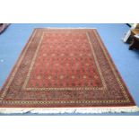 AN AFSHAR STYLE WOOLLEN CARPET SQUARE, red ground and multi strap border, label to underside reading