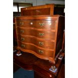 A REPRODUCTION MAHOGANY SERPENTINE CHEST OF THREE DRAWERS, with a bruising slide on ball and claw