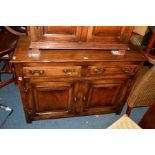 A REPRODUCTION OAK SIDEBOARD with two drawers, width 116.5cm x depth 48cm x height 83cm (two keys)