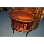 A REPRODUCTION MAHOGANY OVAL DRINKS CABINET with a seperate twin handled tray on four cabriole legs,