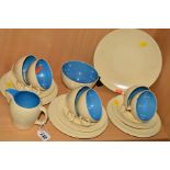 A SUSIE COOPER BROWN WORKS TEASET, plain cream ground with blue interior comprising cake plate, milk