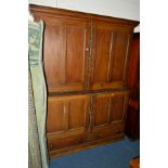 A LATE VICTORIAN SCUMBLED PINE PANELLED FOUR DOOR HOUSEKEEPERS CUPBOARD, turquoise painted interior,