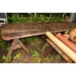 AN EARLY 20TH CENTURY PINE REFECTORY TABLE ON DOUBLE TRESTLE STANDS (average plank width 32cm)