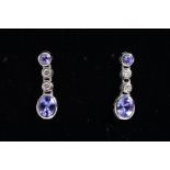 A MODERN PAIR OF 18CT WHITE GOLD TANZANITE AND DIAMOND DROP EARRINGS, post and scroll fittings,