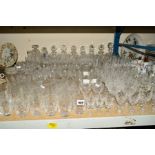 A LARGE QUANTITY OF CUT GLASS ETC, to include nine decanters, Stuart Crystal drinking glasses,
