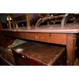 AN EARLY 20TH CENTURY STAINED PINE TABLE with a single drawer, red formica top and metal banding,