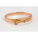 AN EDWARDIAN 9CT GOLD HINGED SPLIT PEARL BUCKLE BANGLE, the belt and buckle design set with split