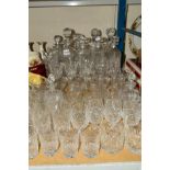 A QUANTITY OF CUT GLASS, to include set of three decanters, tumbler and wine glasses etc