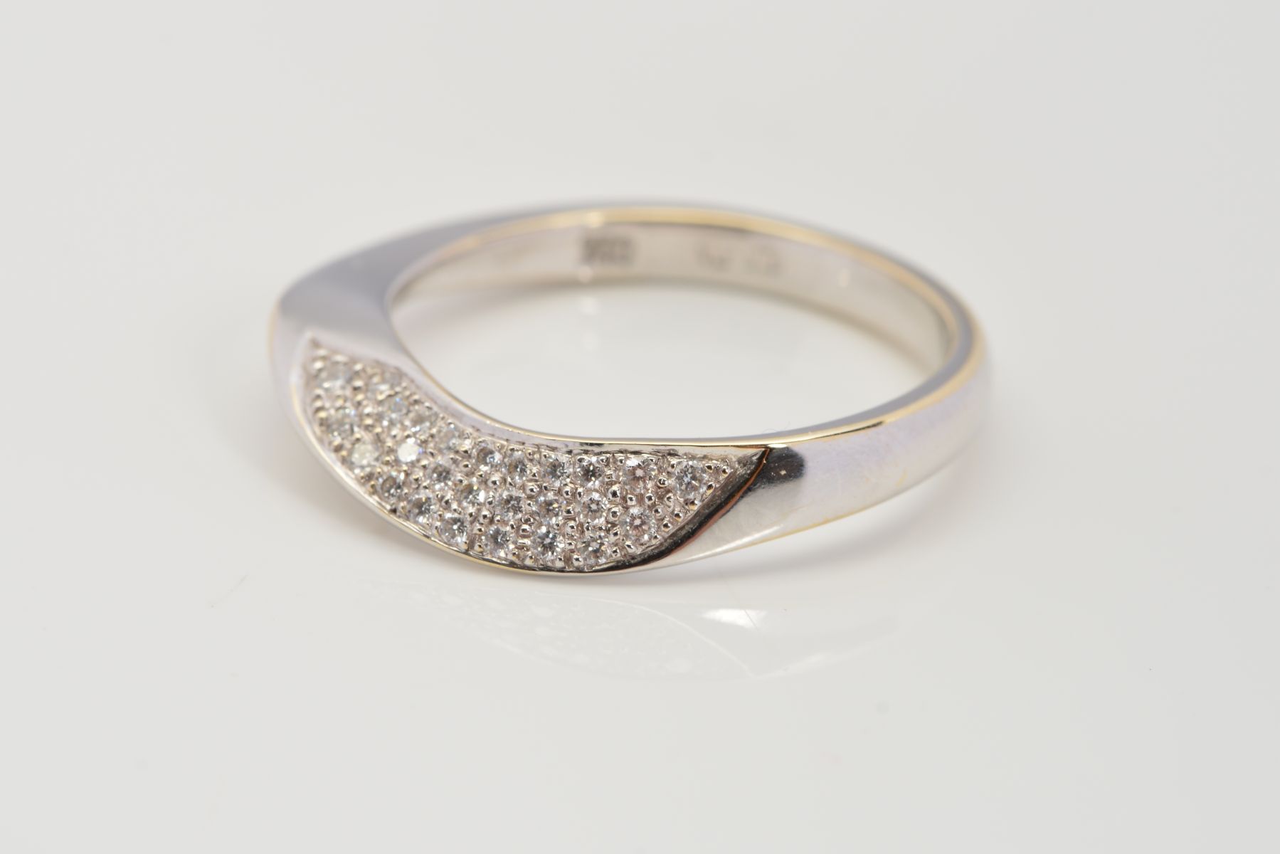 A MODERN ABSTRACT DESIGN 18CT WHITE GOLD DIAMOND WEDDING BAND, estimated pave set diamond weight 0.