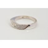 A MODERN ABSTRACT DESIGN 18CT WHITE GOLD DIAMOND WEDDING BAND, estimated pave set diamond weight 0.