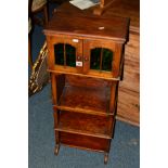 AN EARLY 20TH CENTURY OAK CABINET, having double green glazed cupboard doors above three various