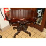 A 19TH CENTURY MAHOGANY CENTRE TABLE having a shaped top, foliate decoration, on four turned