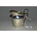 A GEORGE III SILVER HELMET SHAPED CREAM JUG, bright cut engraved decoration, angular handle,