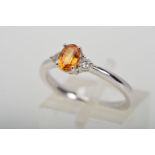 AN 18CT WHITE GOLD ORANGE SAPPHIRE AND DIAMOND THREE STONE RING, estimated total diamond weight 0.