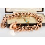 TWO ITEMS OF EARLY 20TH CENTURY JEWELLERY, to include a 9ct gold rose gold charm bracelet fitted