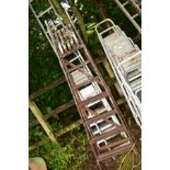 A SET OF SINGLE ALUMINIUM STEP LADDERS, together with a set of wooden step ladders and two aluminium