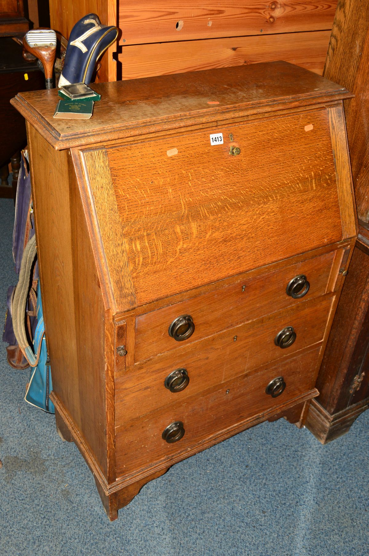 AN OAK FALL FRONT BUREAU with three drawers