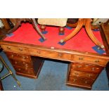 AN EDWARDIAN MAHOGANY PEDESTAL DESK, the top with a red tooled leather inlay top, a single long