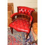 A REPRODUCTION BUTTONED OXBLOOD DIRECTORS CHAIR on cylindrical legs