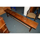 AN EARLY 20TH CENTURY OAK BENCH on a stretchered base, width 185.5cm