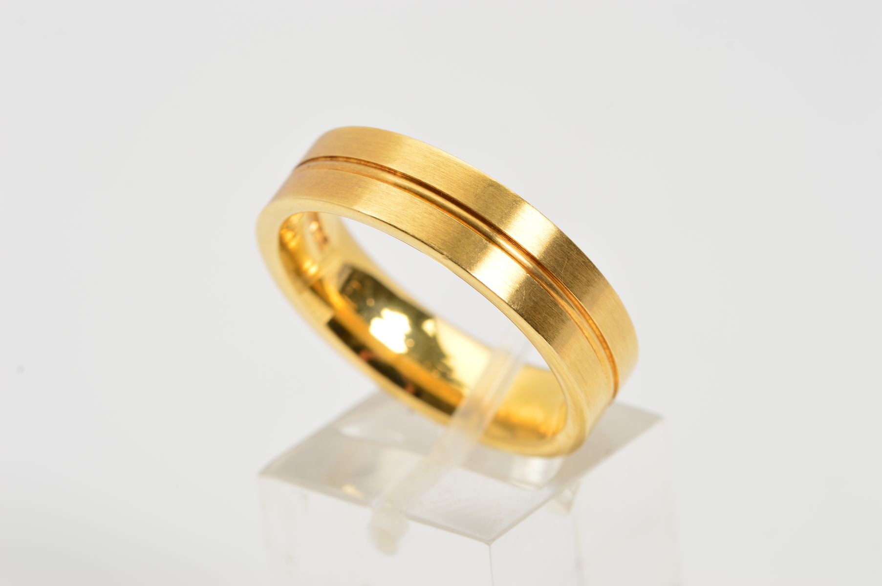 A MODERN 18CT YELLOW GOLD WEDDING RING, flat cross section measuring approximately 6.0mm in width,