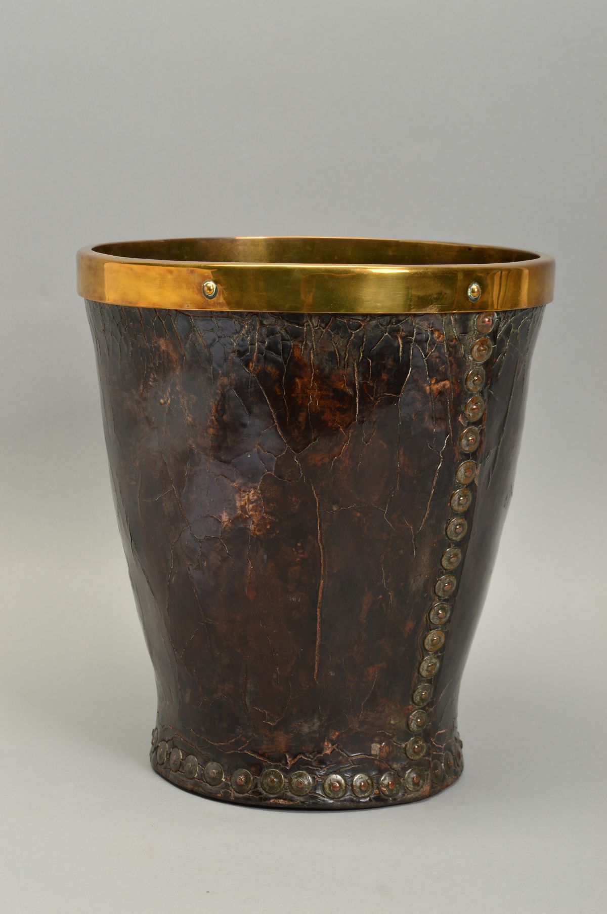 A LEATHER STUD CLOSED AND BRASS BOUND FIRE BUCKET, of tapered form, no handle, height