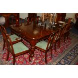 A VICTORIAN MAHOGANY WIND OUT DINING TABLE, two additional leaves on four baluster legs, closed